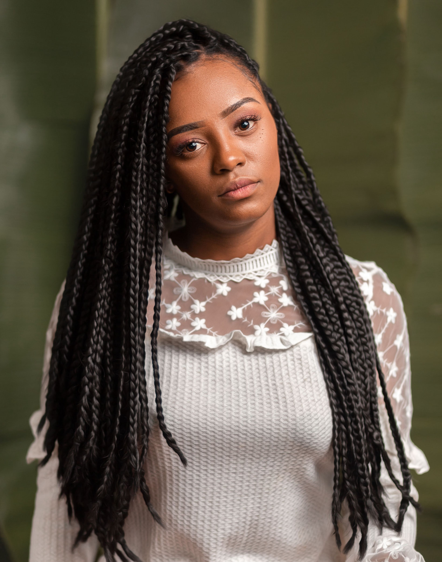 Client with long knotless braids styled by African Hair Gallery Braiding